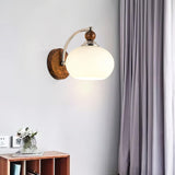 modern-walnut-wood-wall-sconce-with-globe-glass-shade-mid-century-interior-vanity-lighting