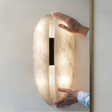 modern-symmetrical-curved-alabaster-led-wall-light-zelda-sconce-for-living-areas