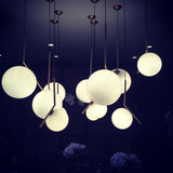 Contemporary Minimalist Equilibrium Glass Globe Pendant Light with Brass and Black Finishes