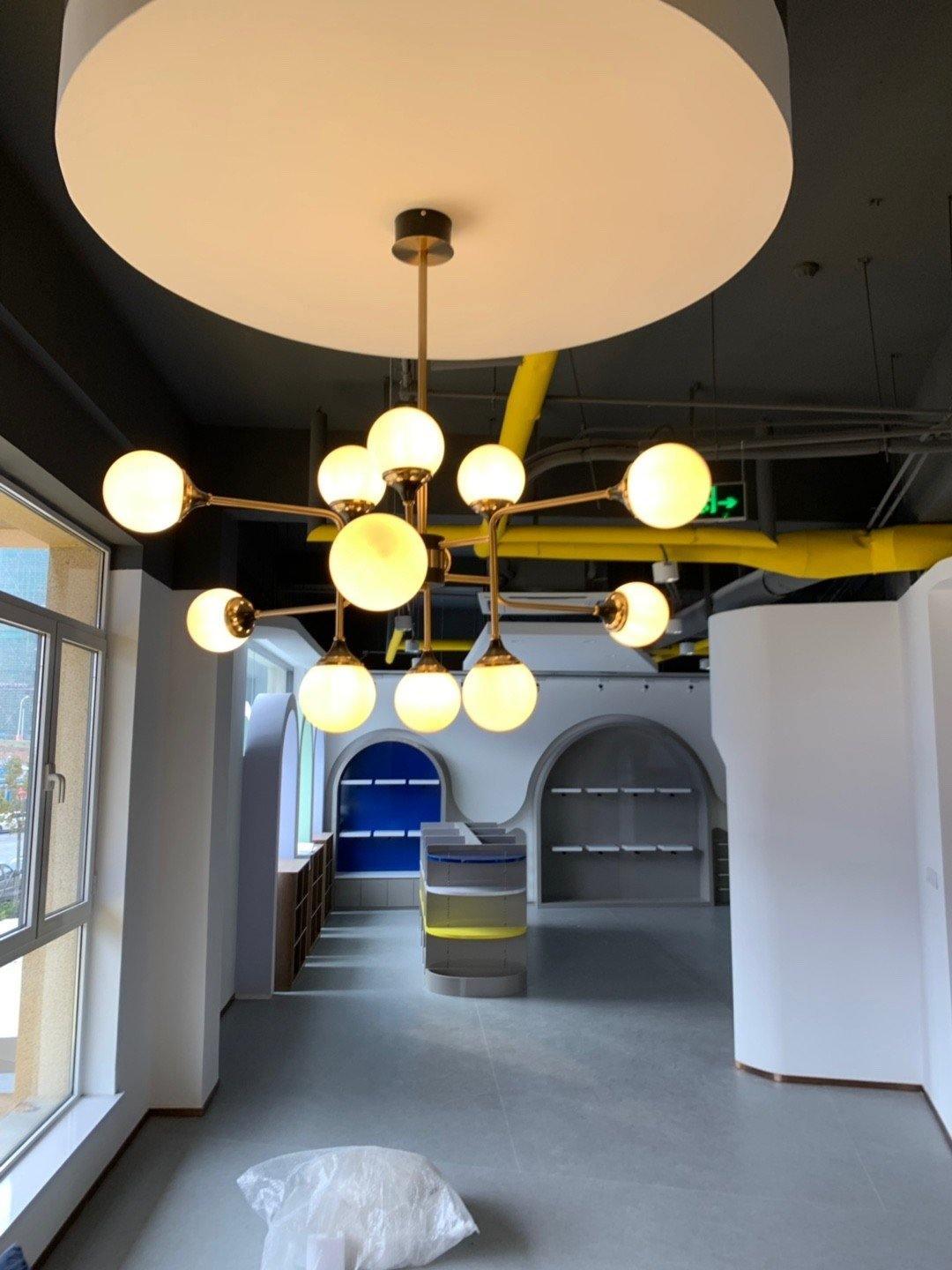 Mid Century Modern Brass Chandelier with Blown White Glass Globes and Bent Arms