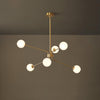 Mid Century Modern Brass Crown Chandelier with White Glass Globe Shades for Indoor Lighting