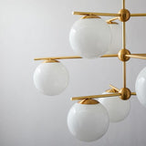 Mid Century Modern Sphere and Stem Chandelier with White Glass Globes and Brass Finish