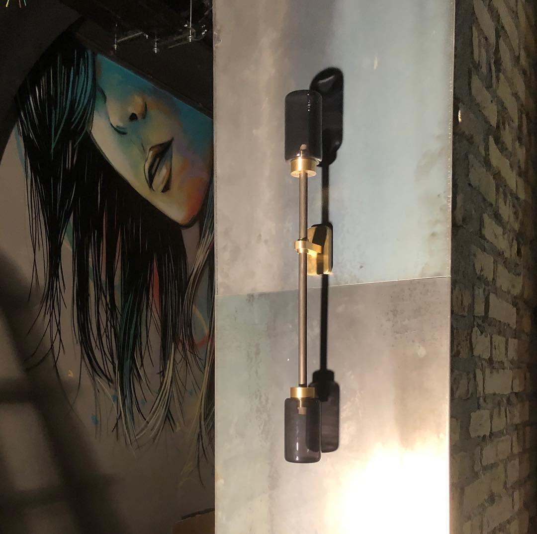 Modern Asymmetric Brass Wall Sconce with Cylindrical Glass Shades for Luxury Interiors