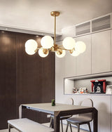 modern-asymmetrical-brass-chandelier-with-opal-glass-globe-shades-for-living-and-dining-rooms