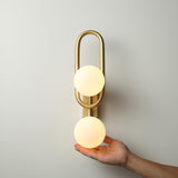 Modern Belisto Gold Wall Lamp with Oval Metal Frame and White Glass Globe Shade