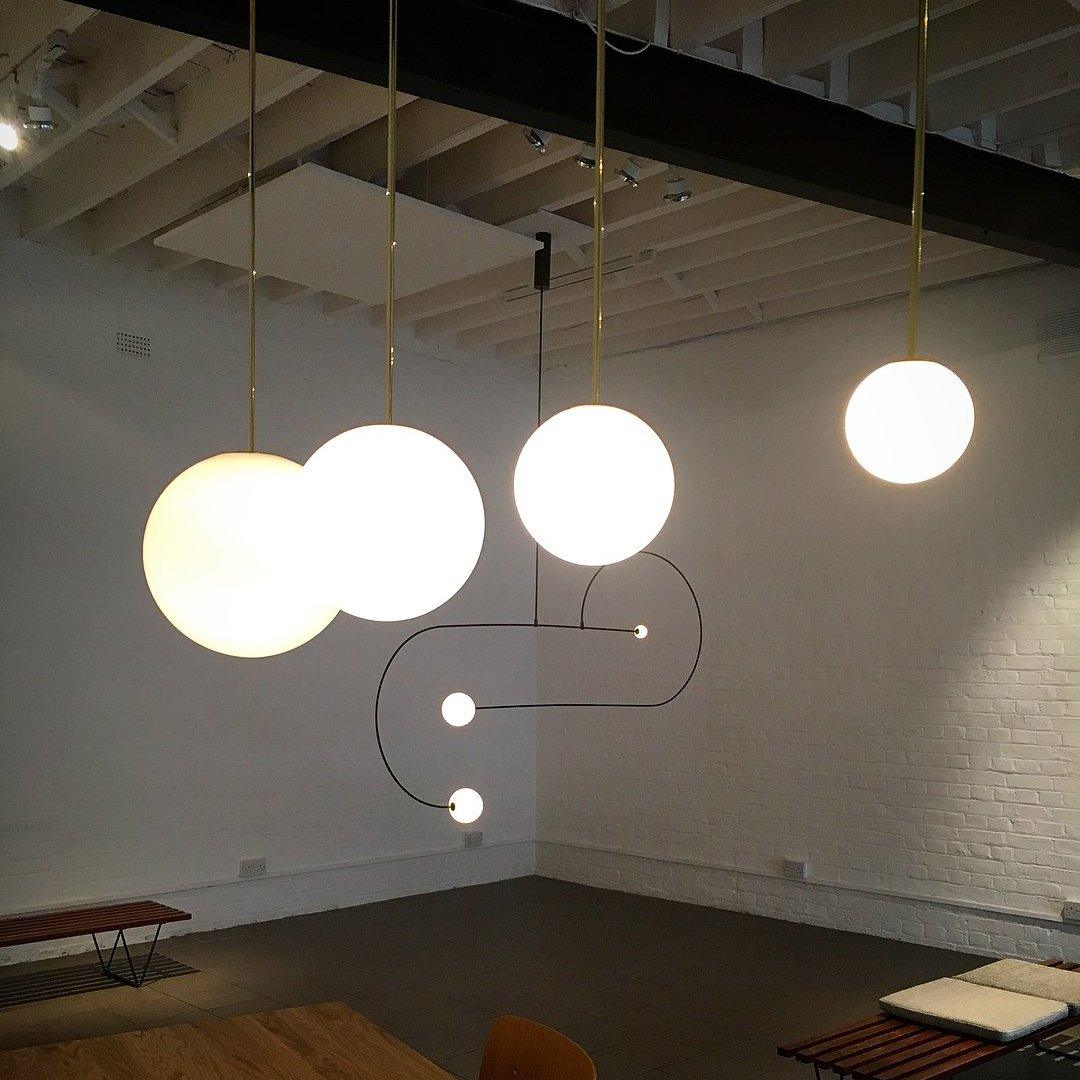 Modern Brass Rod Pendant Light with Spherical Mouth Blown Opal Glass Globe