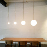 Modern Brass Rod Pendant Light with Spherical Mouth Blown Opal Glass Globe