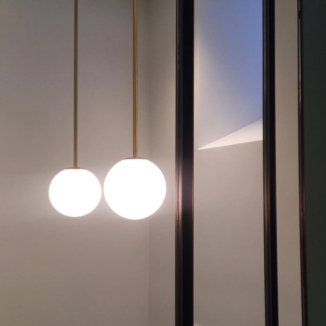 Modern Brass Rod Pendant Light with Spherical Mouth Blown Opal Glass Globe