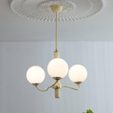 Modern Creamy Yellow Globe Glass Chandelier with White Spherical Shades