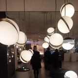 Modern Crescent Brass Pendant Light with Opal Globe Shade and Brushed Fascia