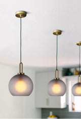 Modern Glass Capsule and Sphere Pendant Light with Copper Finish for Interior Decor