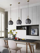 Modern Glass Capsule and Sphere Pendant Light with Copper Finish for Interior Decor