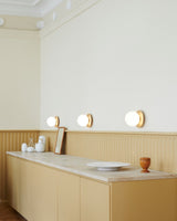 Modern Glass Globe Wall Sconce and Ceiling Lamp with Brass Metal Disc for Elegant Interior Decor
