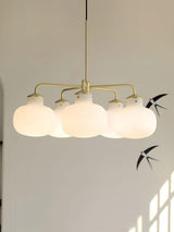 Modern Gold Metal and Opal Glass Globe Pendant Light for Contemporary Interiors