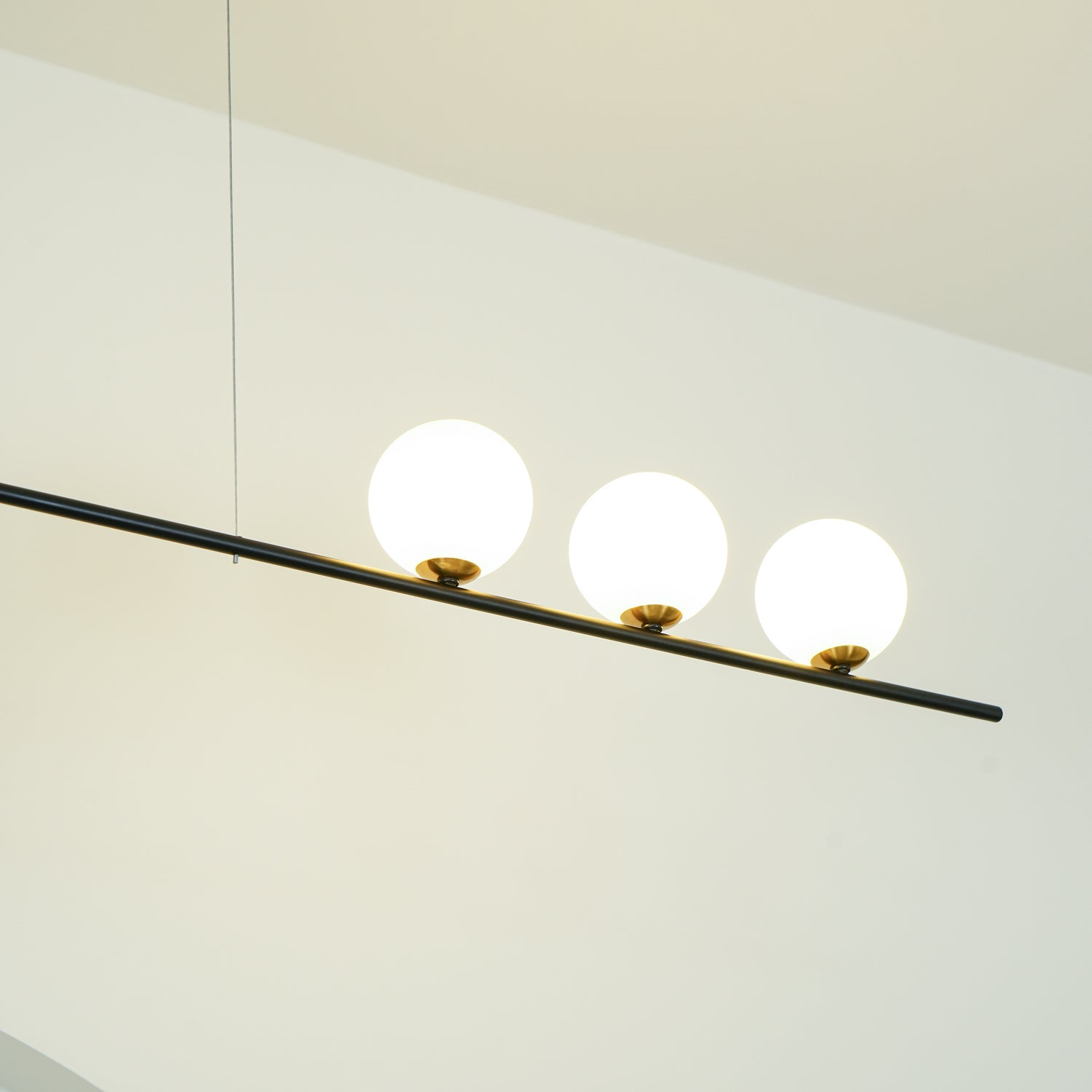 Modern Linear Pendant Chandelier with Opal Glass Globes and Architectural Metallic Design