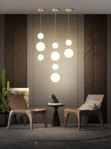 Modern Vertical Glass Globe Pendant Light in Black and Brass Finishes