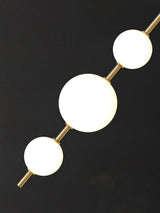 Modern Vertical Glass Globe Pendant Light in Black and Brass Finishes