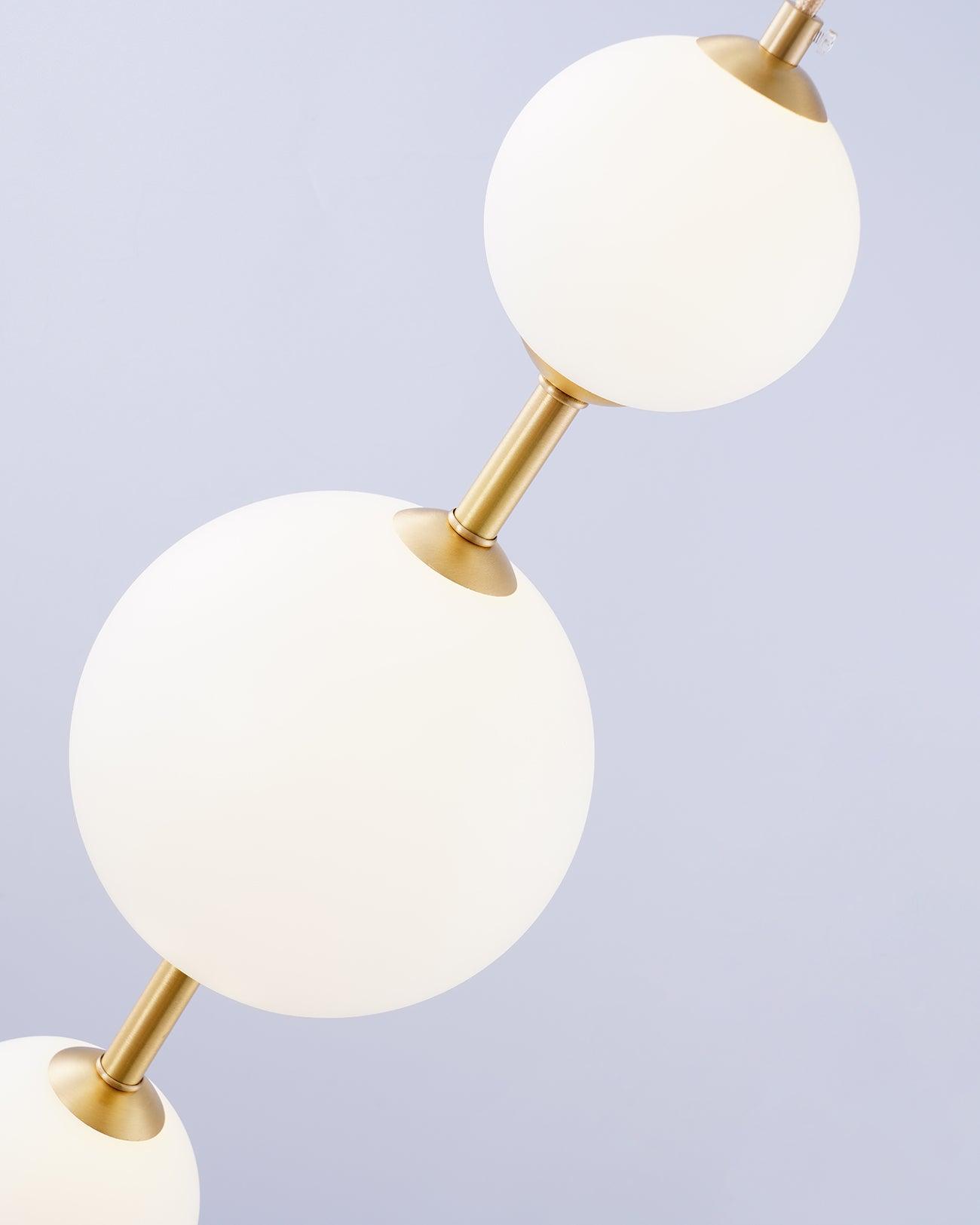 Modern Vertical Glass Globe Pendant Light in Black and Brass Finishes