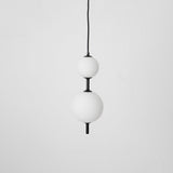 Modern Vertical Glass Globe Pendant Light in Black and Brass Finishes