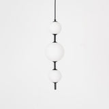 Modern Vertical Glass Globe Pendant Light in Black and Brass Finishes