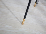 modern-solitaire-tripod-floor-lamp-with-black-polygonal-cloth-shade-and-brass-accents