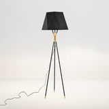 modern-solitaire-tripod-floor-lamp-with-black-polygonal-cloth-shade-and-brass-accents