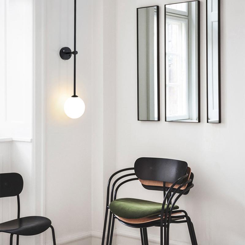 modern-brass-and-opal-glass-sphere-mobile-wall-sconce-lighting-for-indoor-spaces