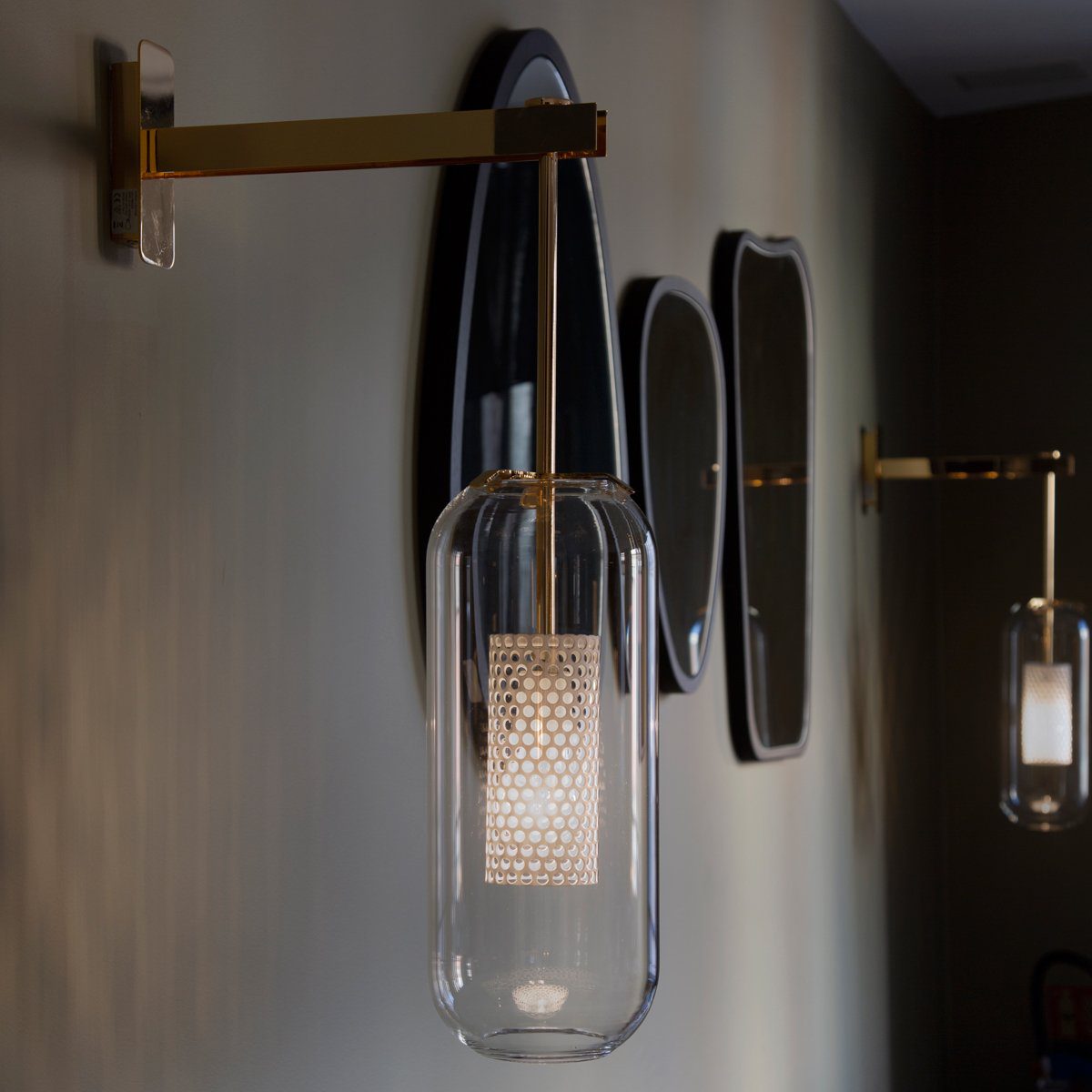 modern-vadim-glass-wall-sconce-with-perforated-metal-cage-and-brass-finish-for-luxury-interiors