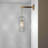 modern-vadim-glass-wall-sconce-with-perforated-metal-cage-and-brass-finish-for-luxury-interiors