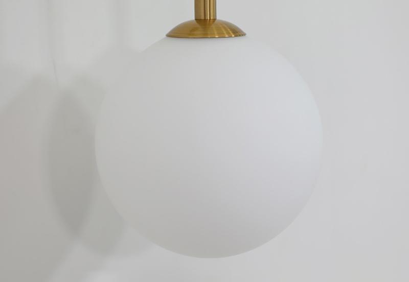 modern-brass-and-opal-glass-sphere-mobile-wall-sconce-lighting-for-indoor-spaces