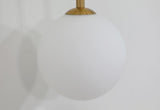 modern-brass-and-opal-glass-sphere-mobile-wall-sconce-lighting-for-indoor-spaces