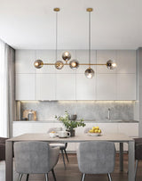 contemporary-multi-glass-globe-pendant-light-with-round-orb-shades-and-polished-brass-frame