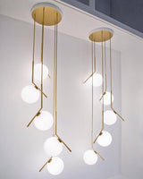 modern-brass-and-opal-glass-globe-pendant-light-minimalist-baton-design-hanging-lamp