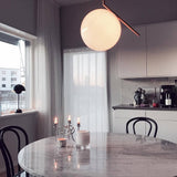 modern-brass-and-opal-glass-globe-pendant-light-minimalist-baton-design-hanging-lamp