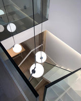 modern-brass-and-opal-glass-globe-pendant-light-minimalist-baton-design-hanging-lamp