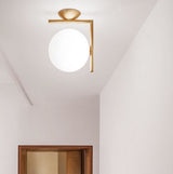 modern-opal-blown-glass-wall-sconce-with-elegant-brass-finish-round-globe-lighting