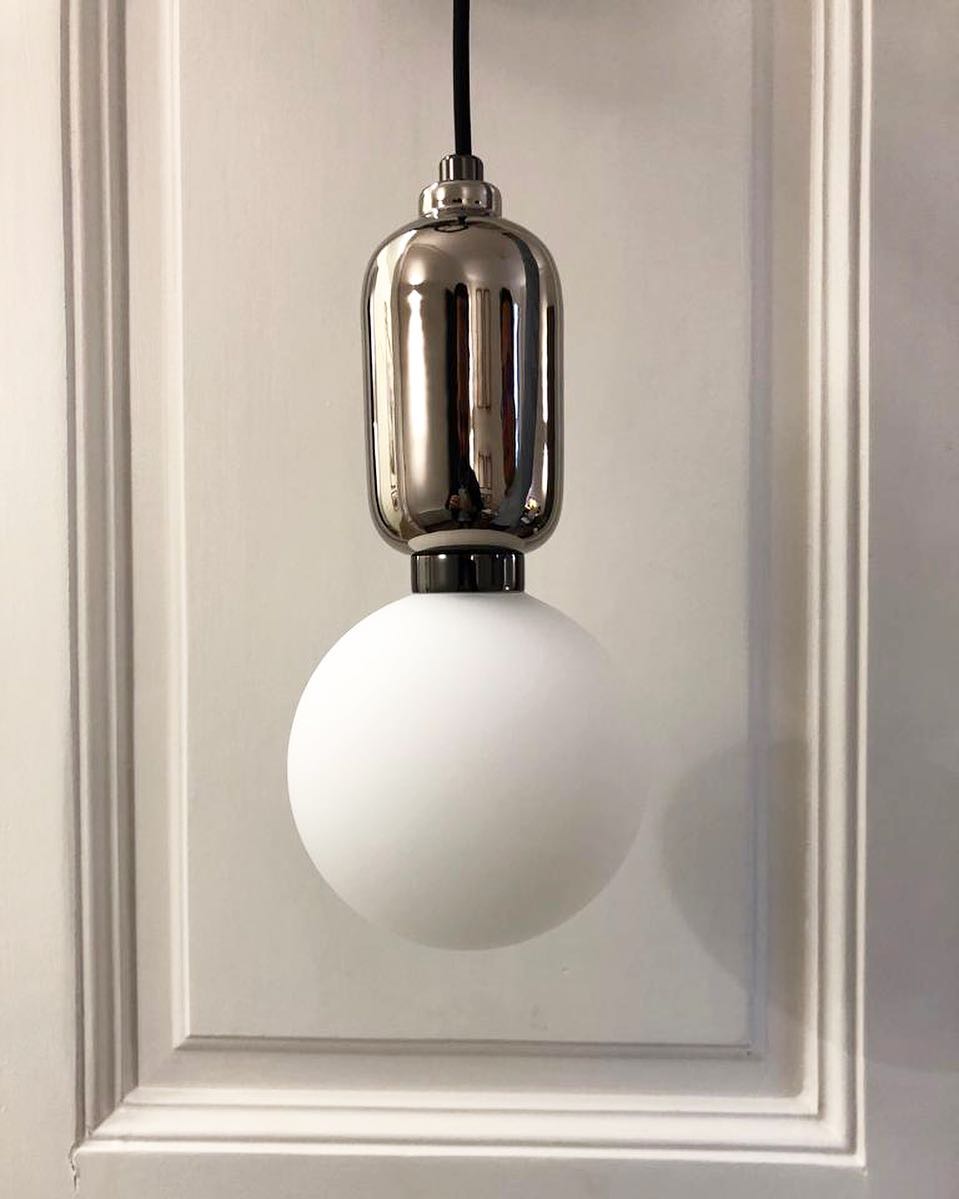 modern-spherical-glass-pendant-light-with-polished-metal-accents-for-luxury-interiors