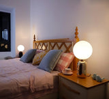 Modern Glass Globe Table Lamp with Polished Metal Frame for Modern Ambient Lighting
