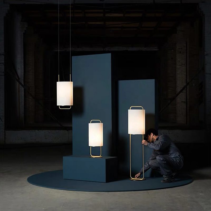 modern-geometric-pendant-light-with-white-fabric-cylindrical-shade-and-gold-metal-finish