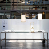 modern-geometric-pendant-light-with-white-fabric-cylindrical-shade-and-gold-metal-finish