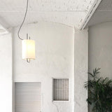 modern-geometric-pendant-light-with-white-fabric-cylindrical-shade-and-gold-metal-finish