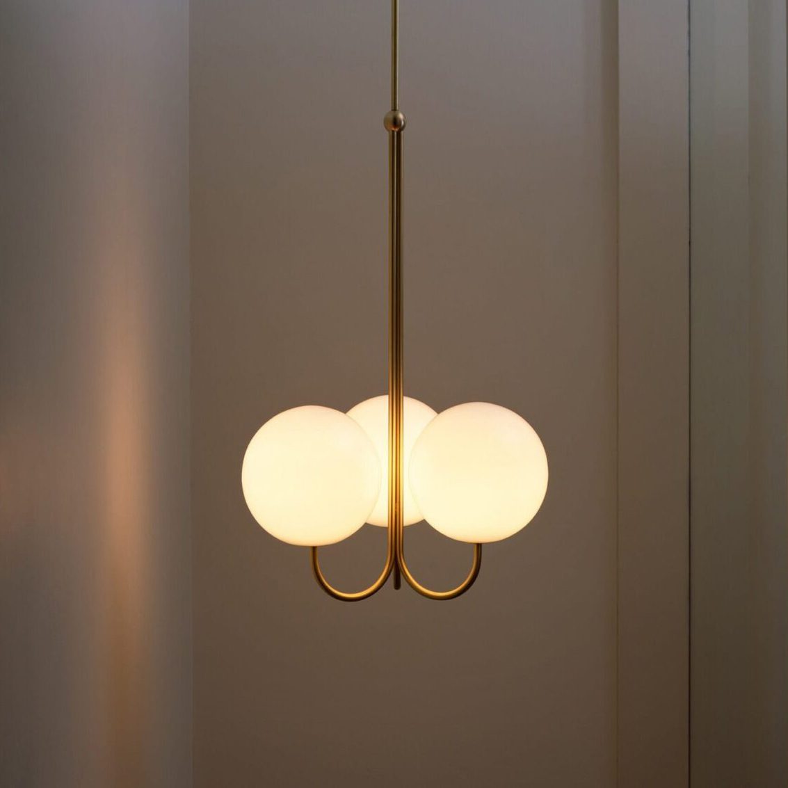mid-century-modern-triple-angle-brass-pendant-lamp-with-opal-glass-globe-shade