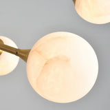 modern-alabaster-globe-chandelier-with-slender-brass-arms-for-luxury-living-room