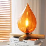 mid-century-campfire-table-lamp-with-orange-glass-shade-and-natural-wood-base