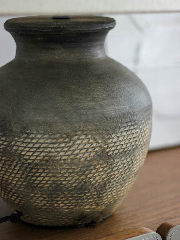rustic-carved-ceramic-table-lamp-with-white-linen-drum-shade-and-handcrafted-earth-toned-finish