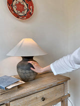 rustic-carved-ceramic-table-lamp-with-white-linen-drum-shade-and-handcrafted-earth-toned-finish