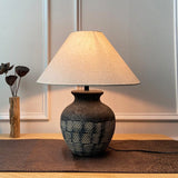 rustic-carved-ceramic-table-lamp-with-white-linen-drum-shade-and-handcrafted-earth-toned-finish