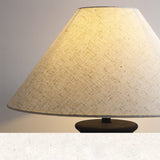 rustic-carved-ceramic-table-lamp-with-white-linen-drum-shade-and-handcrafted-earth-toned-finish