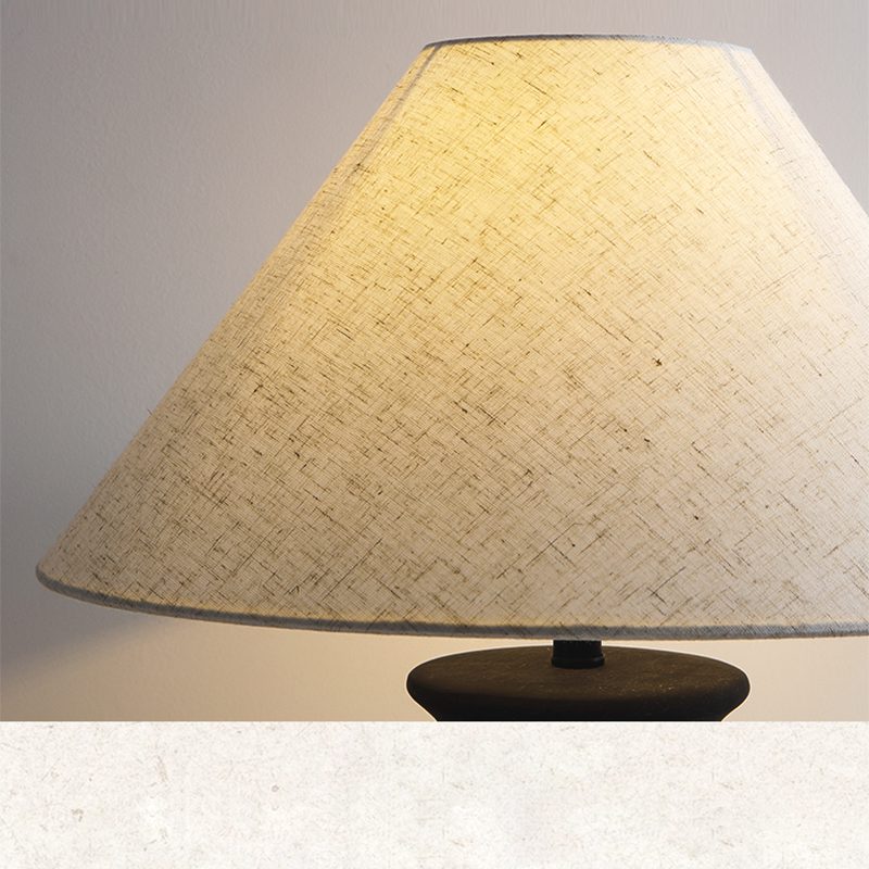 rustic-carved-ceramic-table-lamp-with-white-linen-drum-shade-and-handcrafted-earth-toned-finish
