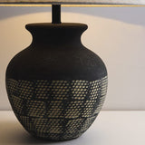rustic-carved-ceramic-table-lamp-with-white-linen-drum-shade-and-handcrafted-earth-toned-finish